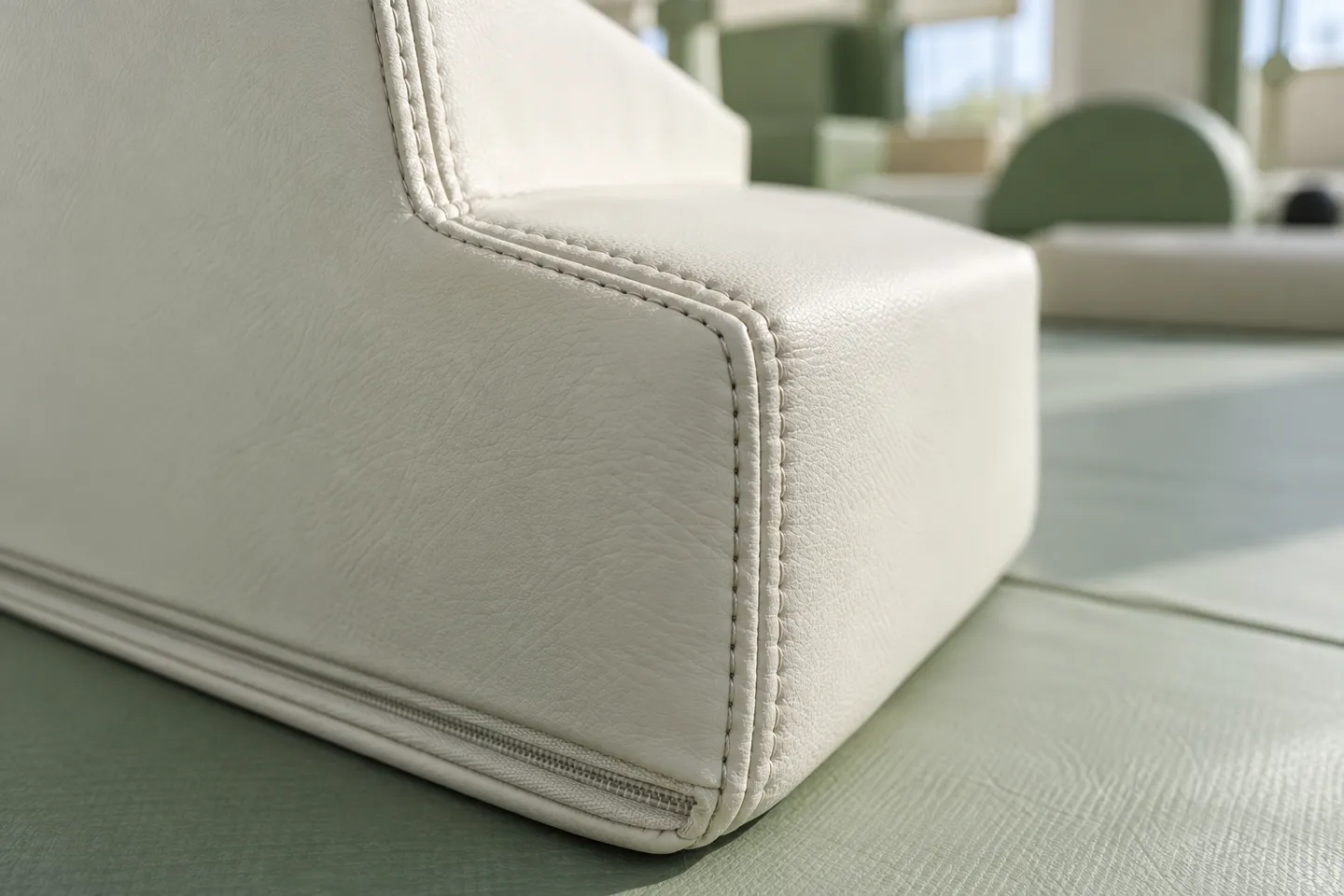 Double-needle stitching and a hidden zipper along the seam of a commercial soft play block's vinyl cover.